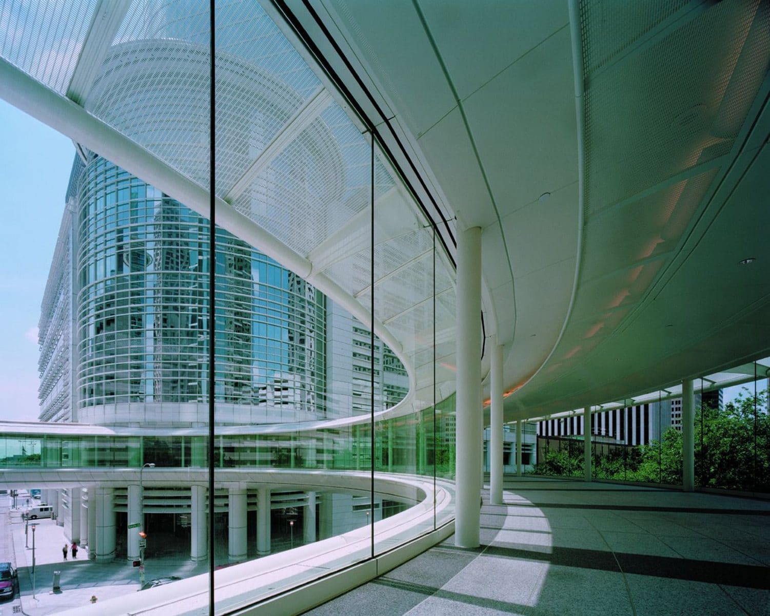 Glass corridor stone flooring by Cangelosi Company