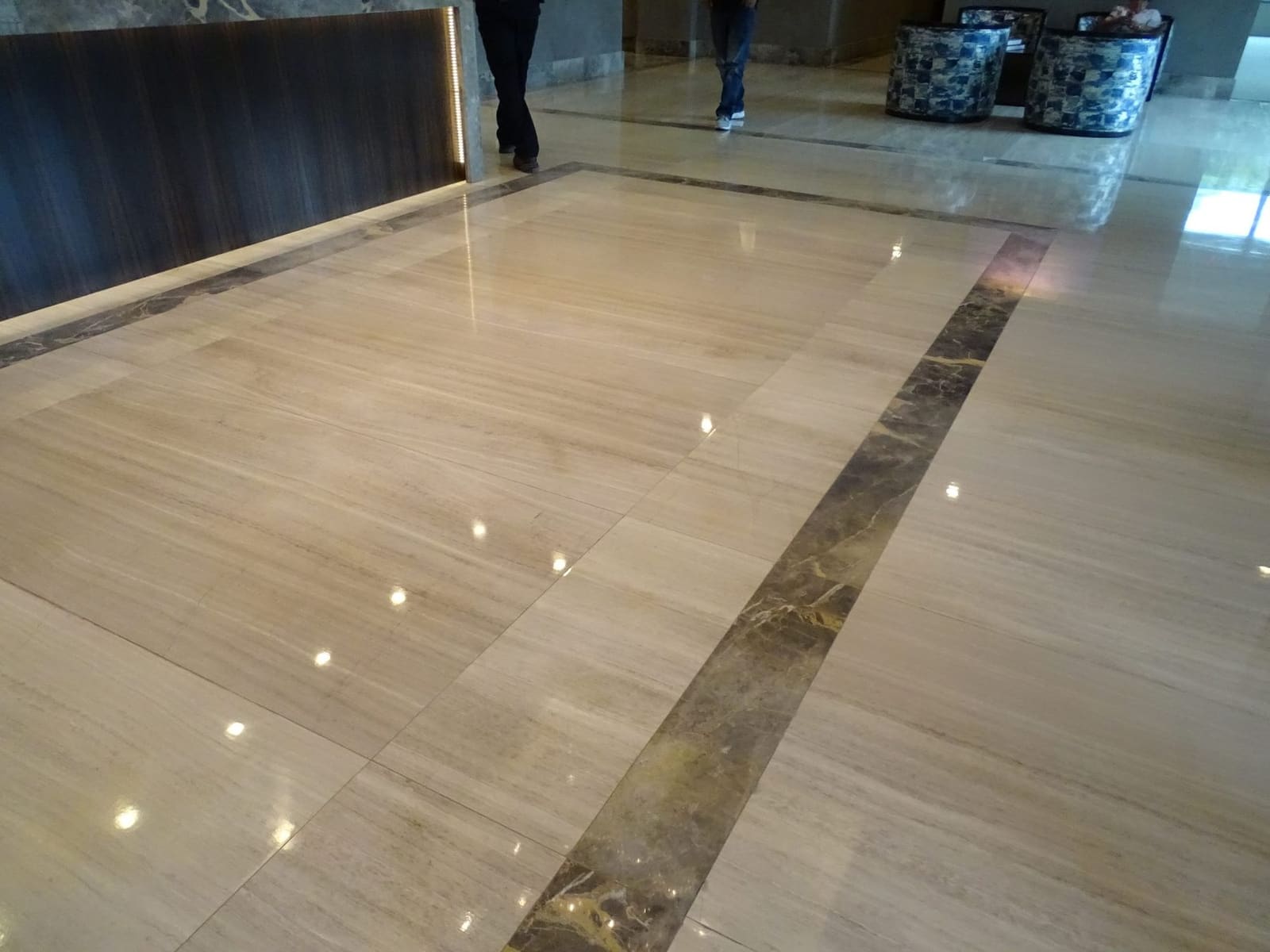 Commercial lobby stone floor with inlay by Cangelosi Company