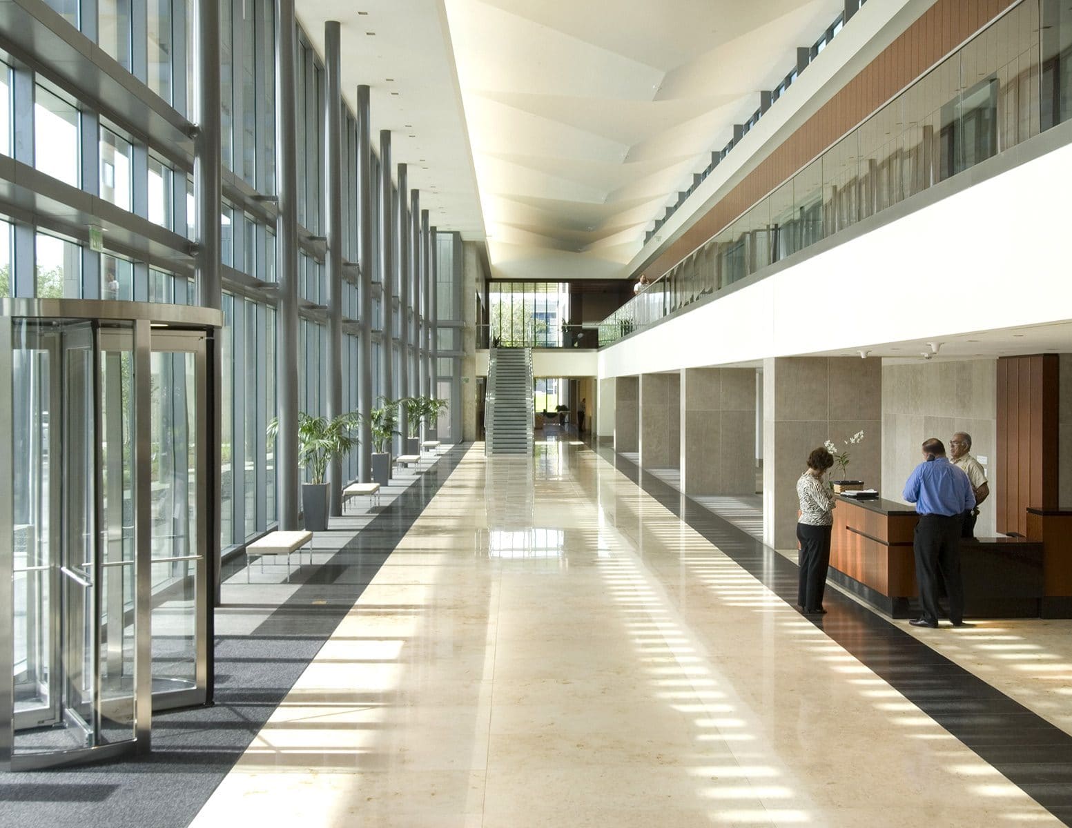 Office corridor stone flooring and wall panels by Cangelosi Company