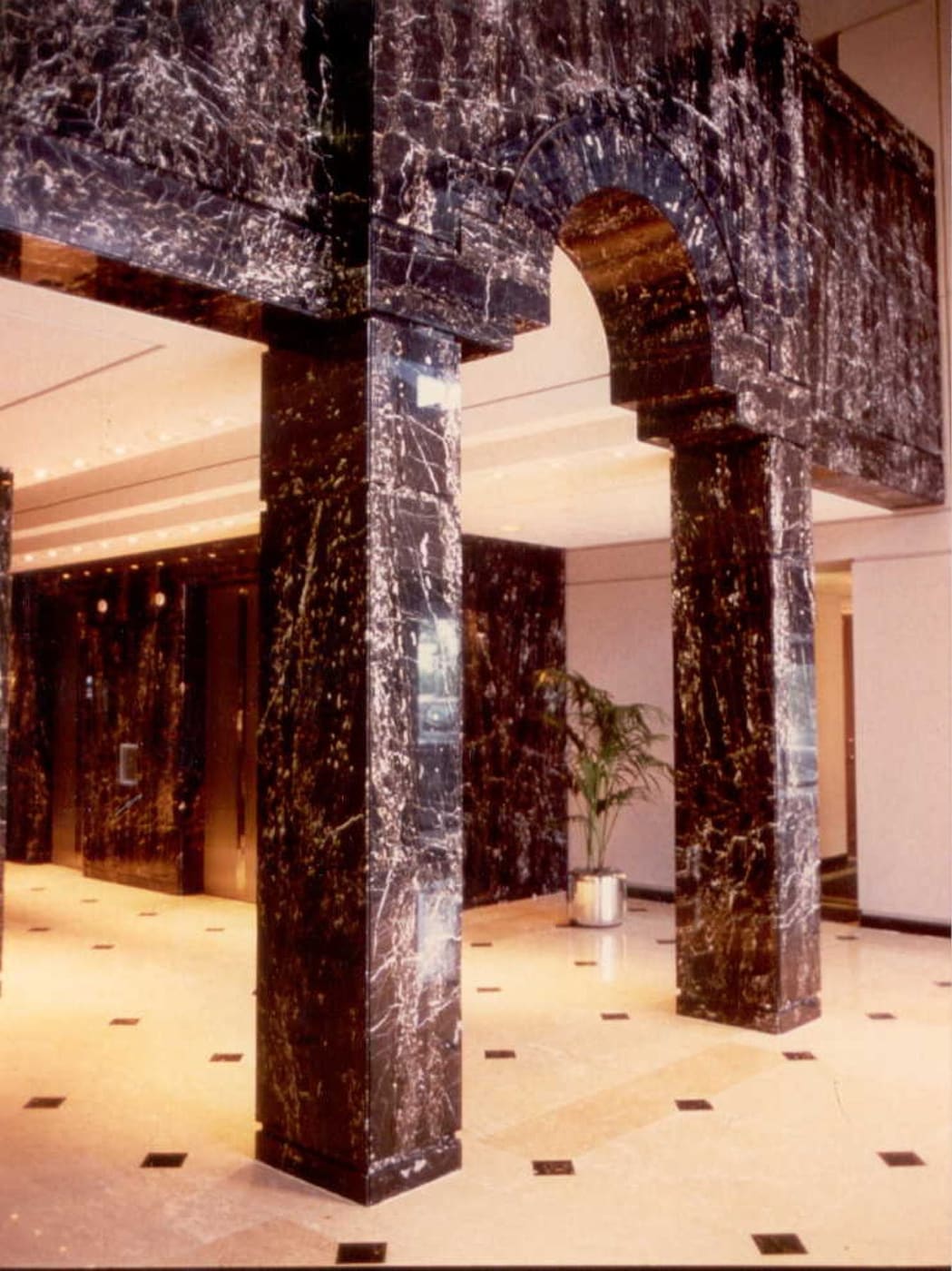 Dark stone entry columns fabricated by Cangelosi Company