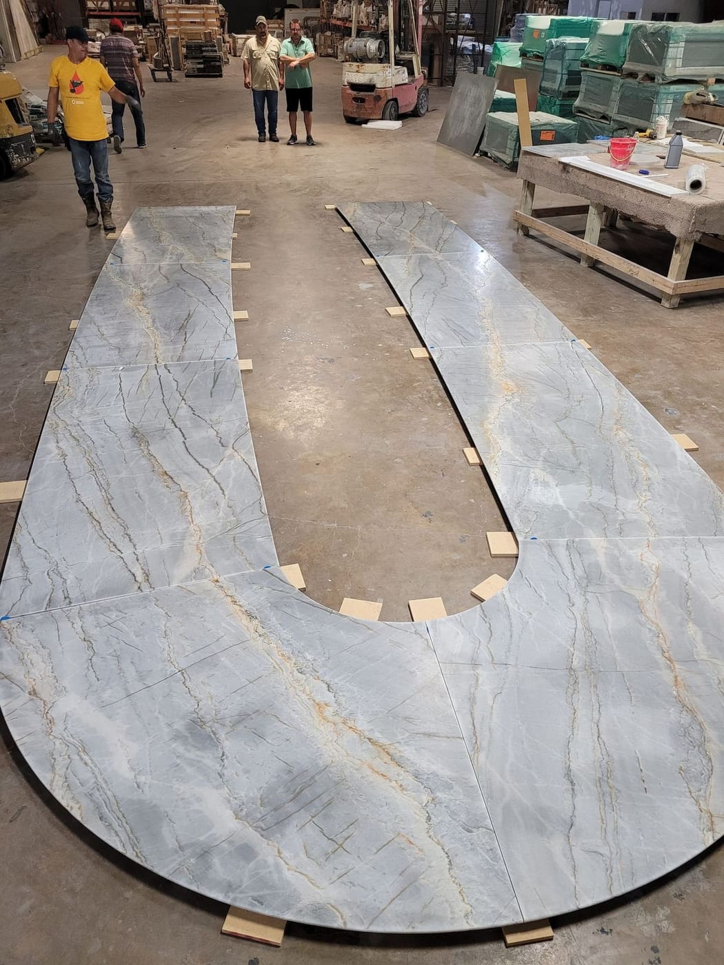 Circular stone table top laid out in the Cangelosi Company shop