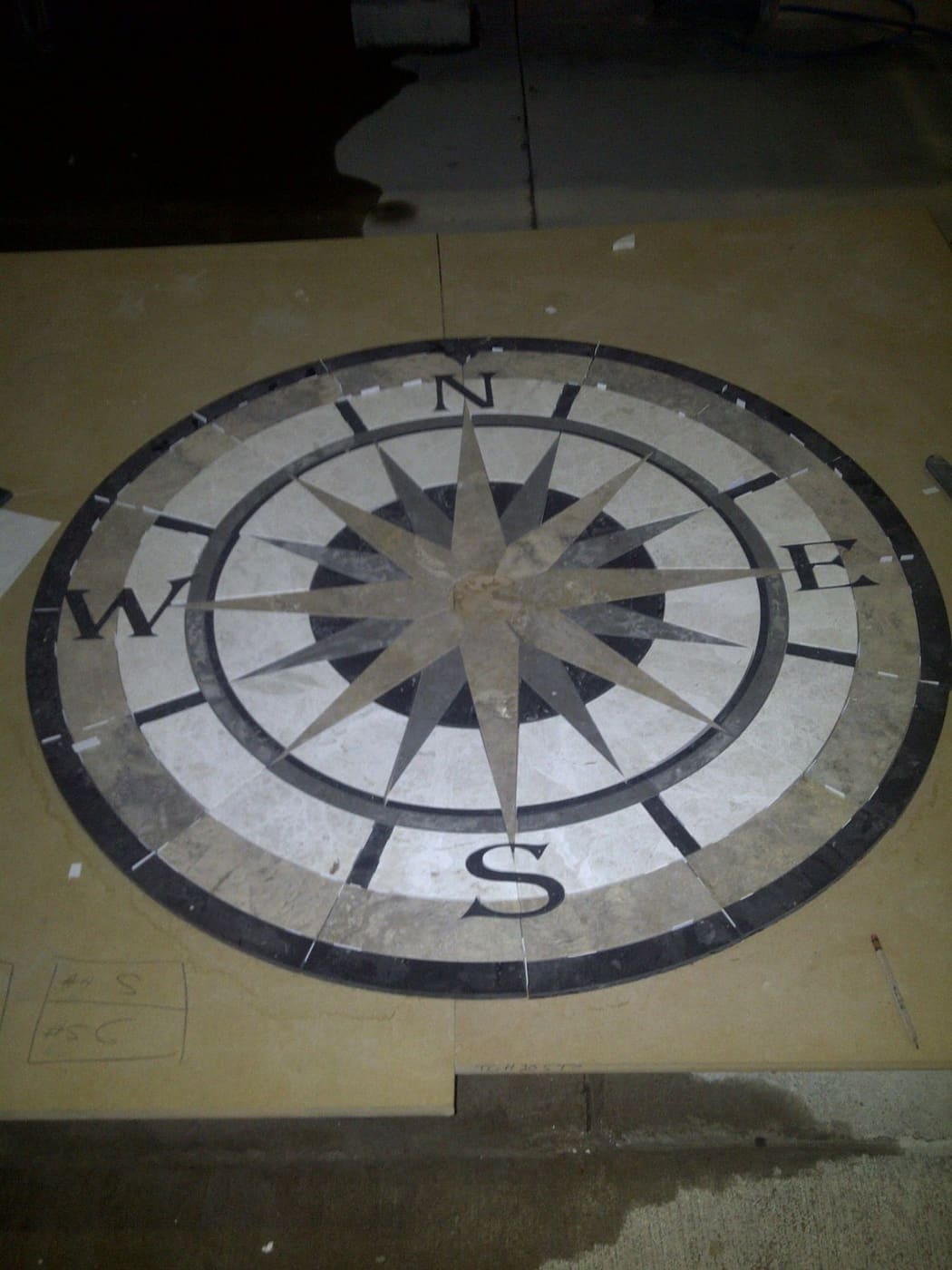 Custom stone floor medallion fabricated and installed by Cangelosi Company