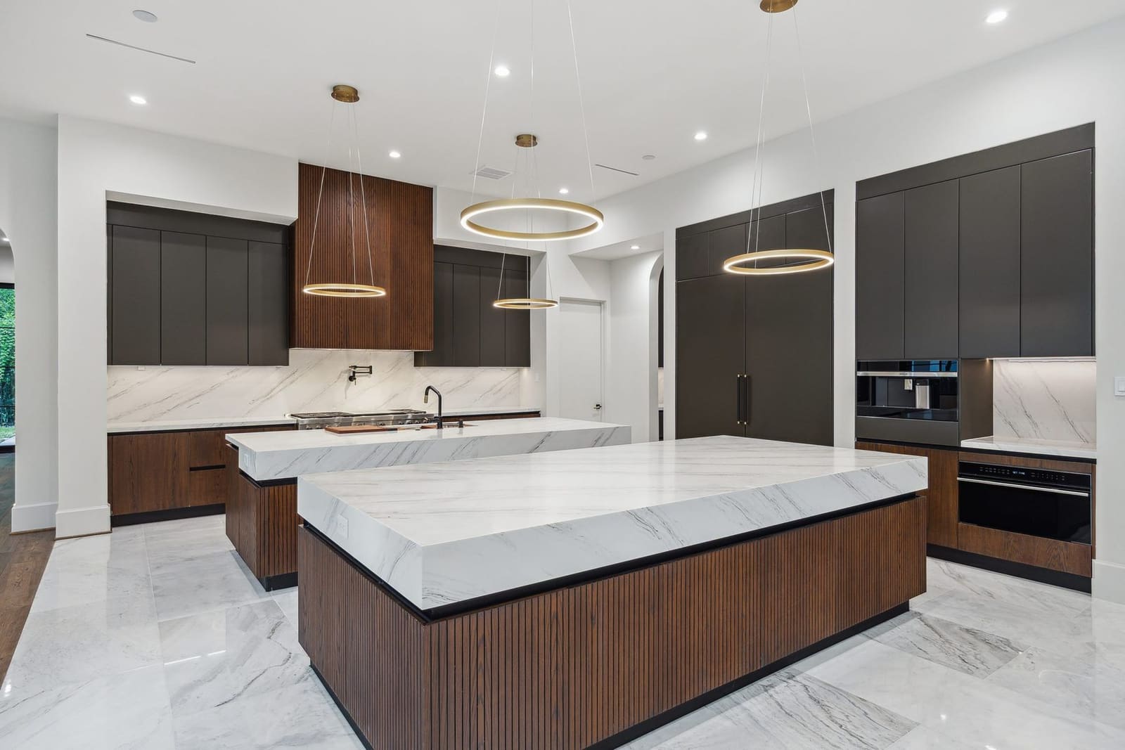 Modern marble waterfall island kitchen fabricated by Cangelosi Company