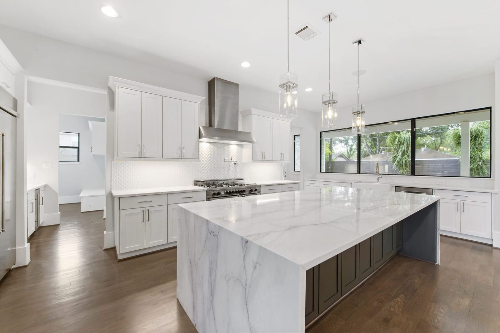 White marble kitchen island by Cangelosi Company