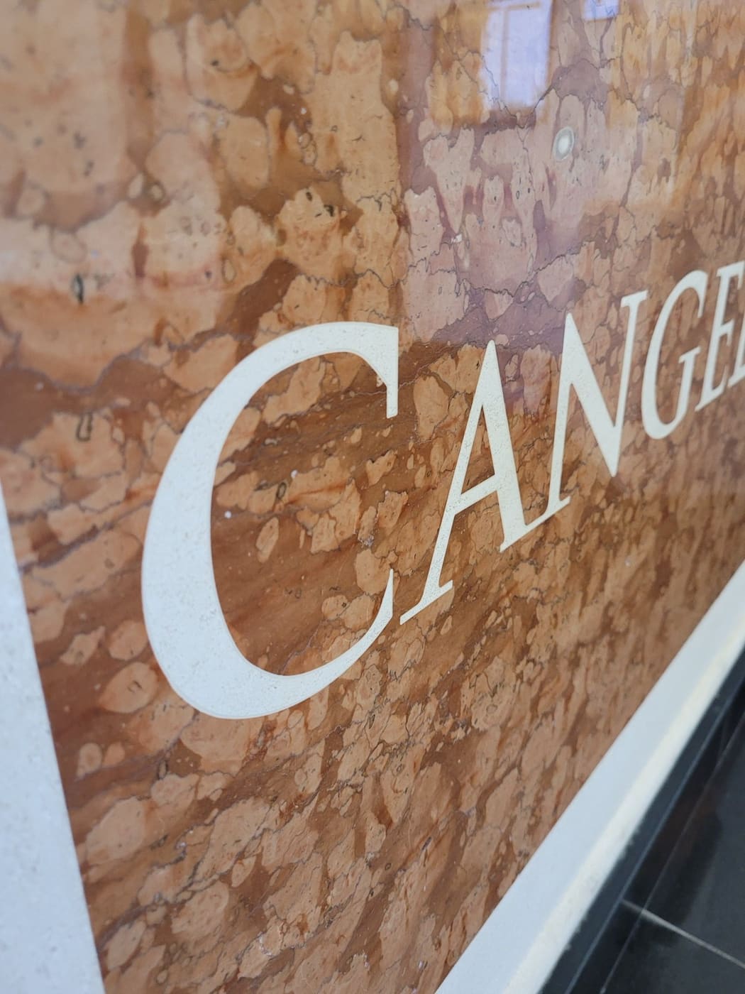 Waterjet-cut lettering detail in natural stone fabricated by Cangelosi Company