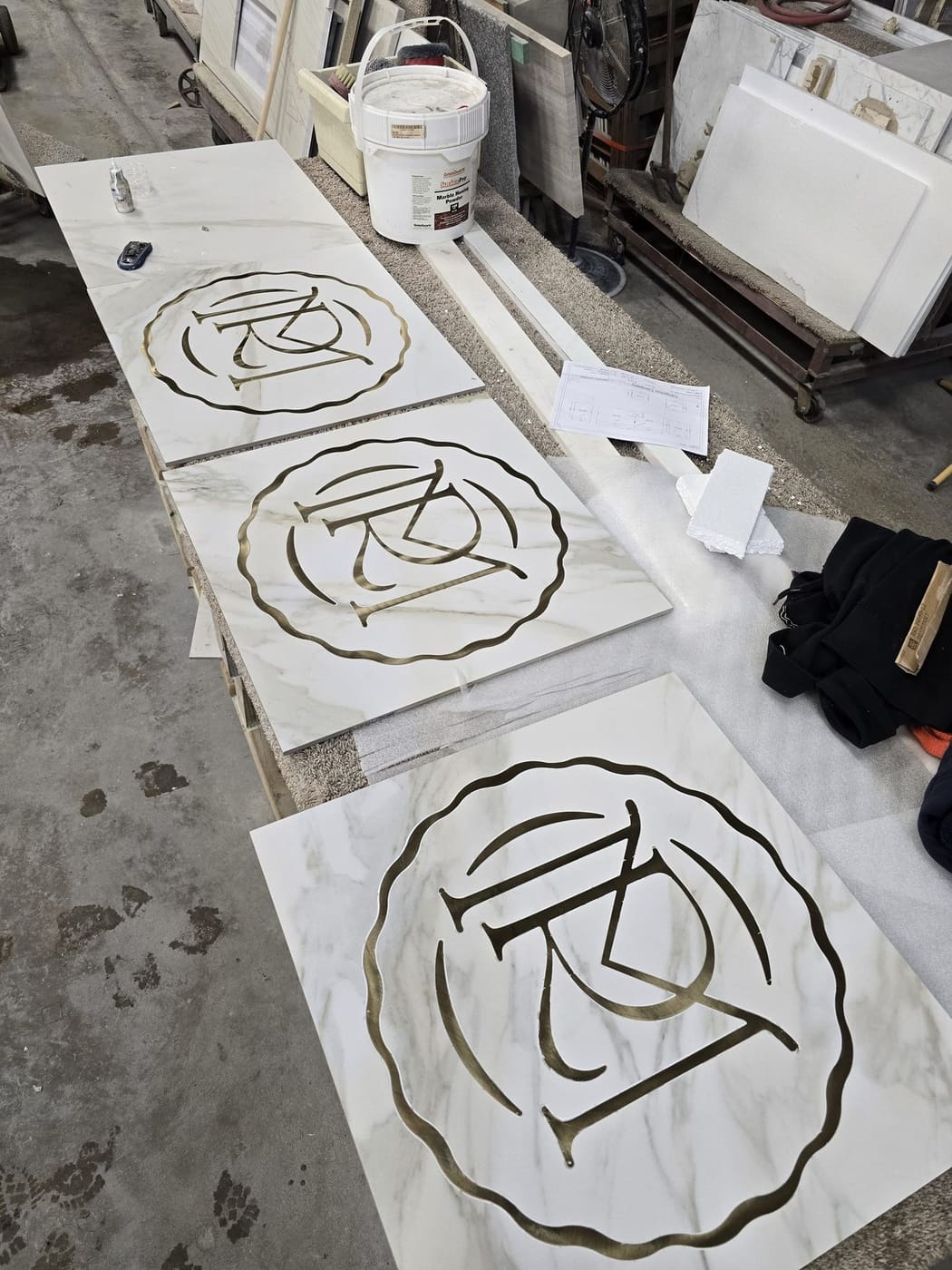 Waterjet-cut stone logo medallions by Cangelosi Company
